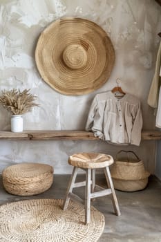 A room with a stool, basket and wicker baskets on the wall