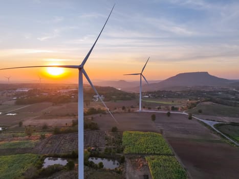 Wind farm field and sunset sky. Wind power. Sustainable, renewable energy. Wind turbines generate electricity. Sustainable development. Green technology for energy sustainability. Eco-friendly energy.