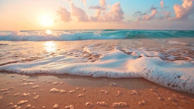A beach with waves and foam on the shore at sunset