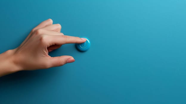 A hand pressing a button on the wall of an office