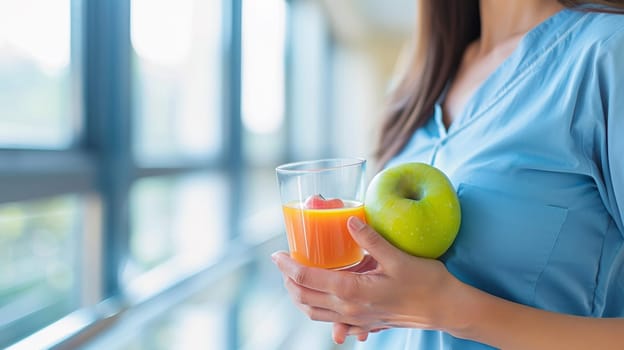 A woman in a blue shirt holding an apple and orange