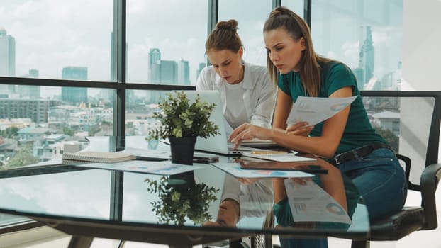 Skilled businesswoman look stress while discuss about financial strategy. Smart business team brainstorming, talking consulting sales plan, idea by using statistic document with tension. Tracery