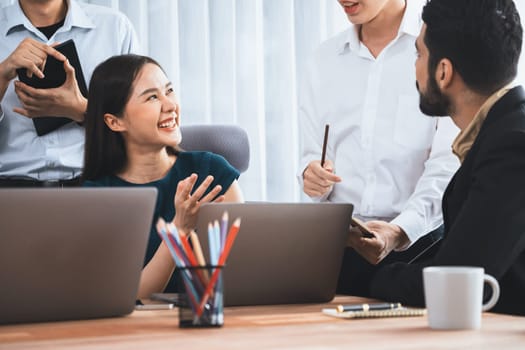 Professional Asian employee work together as team in corporate office, discussing business plans and data to achieve success on desk with laptop. Modern office worker teamwork concept. Concord