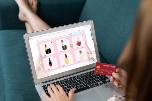 Woman shopping online on internet marketplace browsing for sale items for modern lifestyle and use credit card for online payment from wallet protected by utmost cyber security software