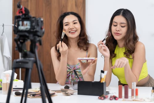 Woman influencer shoot live streaming vlog video review makeup uttermost social media or blog. Happy young girl with cosmetics studio lighting for marketing recording session broadcasting online.