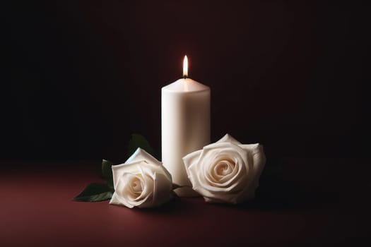 white candle and two white roses on a very dark burgundy background, a symbol of mourning and memory.