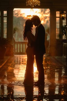 A pair of tango dancers in elegant suits and dresses pose dancing in the sunset light. Attractive man and woman dancing while looking at each other.