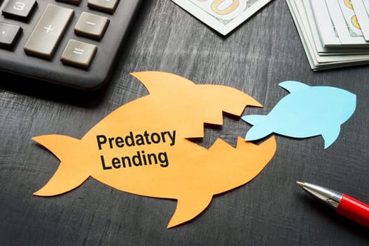 Predatory lending concept. Two paper fish on the table.