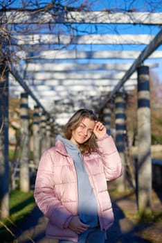 Winter Fun in Bitigheim-Bissingen: Beautiful Girl in Pink Jacket Amidst Half-Timbered Charm. Step into the festive winter spirit with this captivating image of a lovely girl in a pink winter jacket standing in the archway of the historic town of Bitigheim-Bissingen, Baden-Württemberg, Germany. The backdrop features charming half-timbered houses, enhanced by warm vintage photo processing, creating a delightful scene of winter joy and architectural beauty.