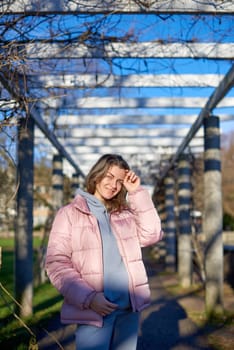 Winter Fun in Bitigheim-Bissingen: Beautiful Girl in Pink Jacket Amidst Half-Timbered Charm. Step into the festive winter spirit with this captivating image of a lovely girl in a pink winter jacket standing in the archway of the historic town of Bitigheim-Bissingen, Baden-Württemberg, Germany. The backdrop features charming half-timbered houses, enhanced by warm vintage photo processing, creating a delightful scene of winter joy and architectural beauty.