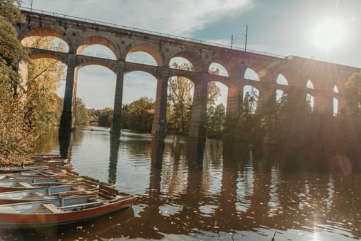 Railway Bridge with river in Bietigheim-Bissingen, Germany. Autumn. Railway viaduct over the Enz River, built in 1853 by Karl von Etzel on a sunny summer day. Bietigheim-Bissingen, Germany. Old viaduct in Bietigheim reflected in the river. Baden-Wurttemberg, Germany. Train passing a train bridge on a cloudy day in Germany.