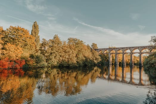 Railway Bridge with river in Bietigheim-Bissingen, Germany. Autumn. Railway viaduct over the Enz River, built in 1853 by Karl von Etzel on a sunny summer day. Bietigheim-Bissingen, Germany. Old viaduct in Bietigheim reflected in the river. Baden-Wurttemberg, Germany. Train passing a train bridge on a cloudy day in Germany