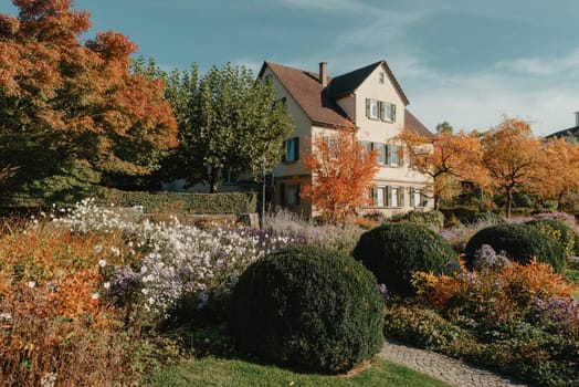 House with nice garden in fall. Flowers in the Park. Bietigheim-Bissingen. Germany, Europe. Autumn Park and house, nobody, bush and grenery