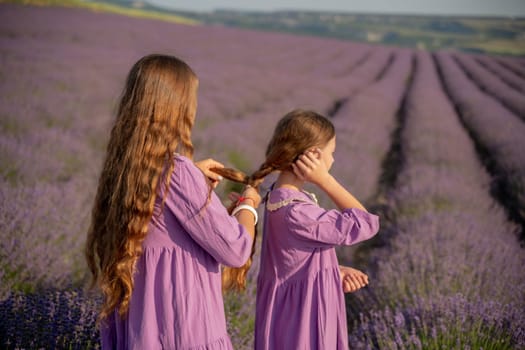 Mom and daughter braiding each other's hair in a field of lavender. The scene is peaceful and serene, with the girls enjoying each other's company and the beauty of their surroundings.