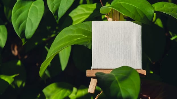 Blank white billboard against green lemongrass leaves garden. Empty mockup template label at farm land. Copy space banner for your text. Agricultural landscape advertisement sample