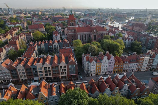 Beautiful panoramic architecture of old town in Gdansk, Poland at sunrise. Aerial view drone pov. Landscape cityscape City from Above. Small vintage historical buildings Europe Tourist Attractions travel destination in Gdansk