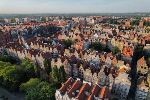 Beautiful panoramic architecture of old town in Gdansk, Poland at sunrise. Aerial view drone pov. Landscape cityscape City from Above. Small vintage historical buildings Europe Tourist Attractions travel destination in Gdansk