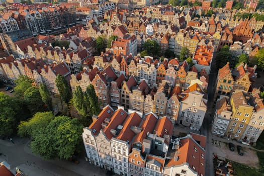 Beautiful panoramic architecture of old town in Gdansk, Poland at sunrise. Aerial view drone pov. Landscape cityscape City from Above. Small vintage historical buildings Europe Tourist Attractions travel destination in Gdansk