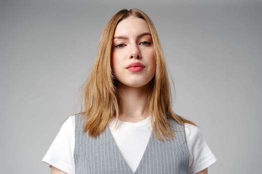 Young Woman Wearing Gray Suit and White Shirt on gray background