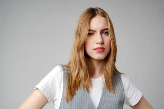 Young Woman Wearing Gray Suit and White Shirt on gray background