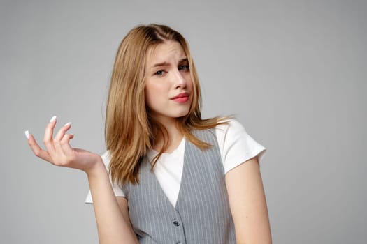 Young Woman Wearing Gray Suit and White Shirt on gray background