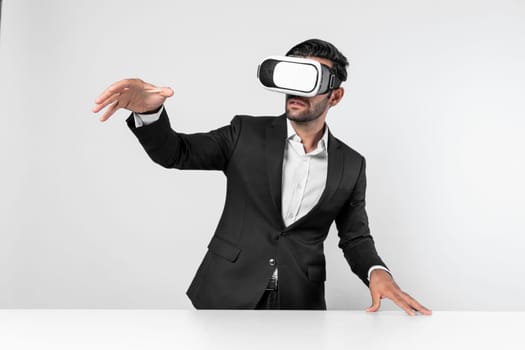 Smart businessman standing at table with laptop while choosing data analysis by using technology innovation. Skilled caucasian project manager using virtual reality glasses and VR goggles. Deviation.
