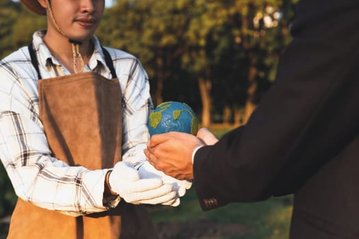 Eco-business company empower farmer with eco-friendly farming practice and clean agricultural technology. Cultivate sustainable future and holding Earth globe symbolize commitment to environment.Gyre