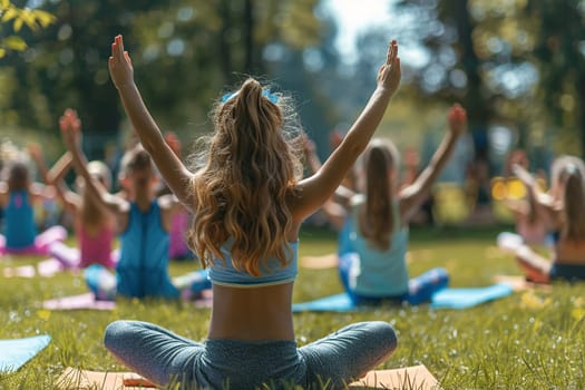 Rear view of a group of children sitting on the grass outdoors. The concept of children's gymnastics, fitness, sport.