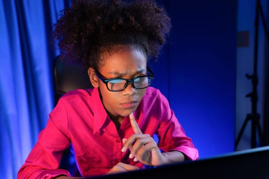 African woman businesswoman or blogger wearing pink shirt with serious face, looking and focusing on screen laptop with struggle project. Concept of stressful expression at work from home. Tastemaker.