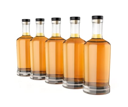 Row with five whisky bottles on white background