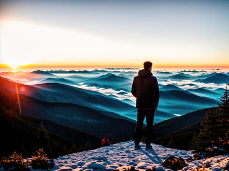 The image shows a person standing on a mountain summit at sunset, looking out over the mountains and valleys below.