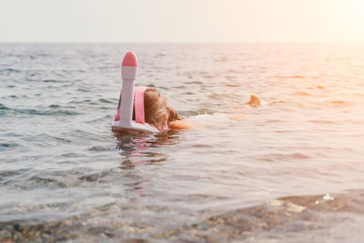 Young happy woman in white bikini put pink snorkeling mask on beach before swimming. girl having fun relaxing on beautiful beach. Beach lifestyle