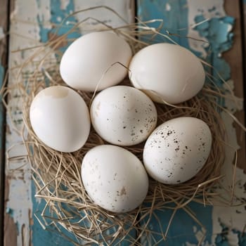 Feast of the Lord's Resurrection: White eggs in a nest on a blue wooden background. Top view.