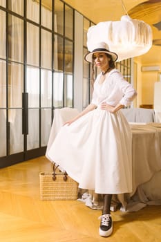 Beautiful tender woman in white dress posing. Beauty, fashion. Haircare. Cosmetics