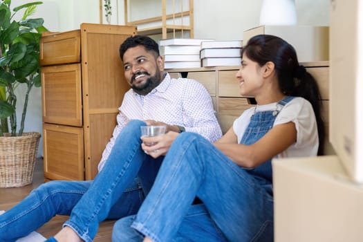 Married couple moving in new property bought together on mortgage loan.