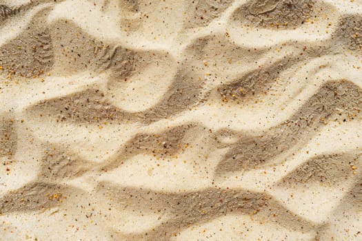 Textured sandy beach surface with ripples and granules of sand, close up. Nature pattern and texture concept. Background for design and display. Ai generation. High quality photo