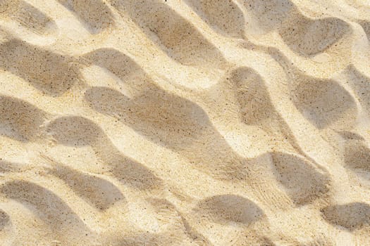 Textured sandy beach surface with ripples and granules of sand, close up. Nature pattern and texture concept. Background for design and display. Ai generation. High quality photo