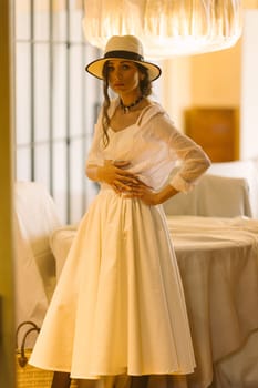 Beautiful tender woman in white dress posing. Beauty, fashion. Haircare. Cosmetics