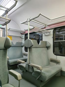 interior of a commuter train car with soft seats close-up