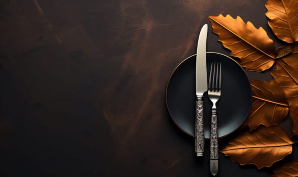 Banner: Autumn table setting. Fork, knife and autumn leaves on dark background