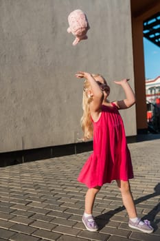 Child with hearing problem and cochlear implant dance in street, deaf kid began to hear. Hearing loss in childhood and treatment concept. Copy space and empty place for text.