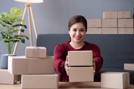 SME business entrepreneurs small in asia Preparing cardboard boxes in home office Small business operators preparing to ship to customers.