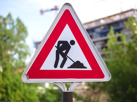 A construction sign with a triangle design. road works are underway. Red triangle sign with silhouette working person inside. High quality photo