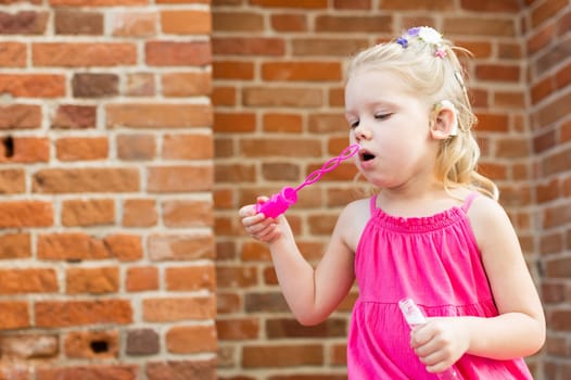 Child head with cochlear implant hearing aid. Hearing aid and medicine innovating technology and diversity concept