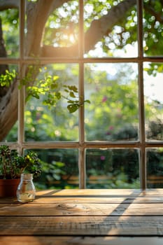 A window with a potted plant sitting on a wooden table. The sunlight is shining through the window, creating a warm and inviting atmosphere