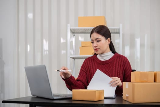 SME business entrepreneurs small in asia Preparing cardboard boxes in home office Small business operators preparing to ship to customers.