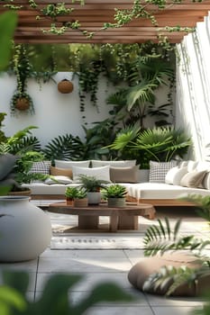A patio featuring a couch, table, and potted plants adding a touch of nature with vegetation, shrubs, and houseplants in an urban design setting
