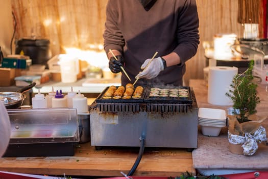 Process of cooking takoyaki balls. Japanese snacks and street food at the festival