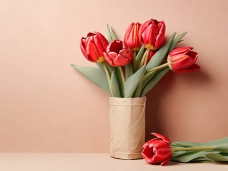 Beautiful red tulips in craft paper on beige pastel background with copy space, spring time, mother's day
