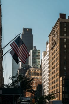 A single American flag stands out against the urban backdrop of NYC.